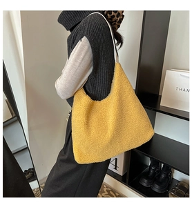 Detail of the textured yellow fleece shoulder bag with a slim white leather strap