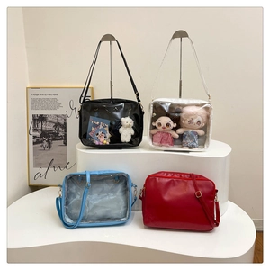 Detail view of four colorful Ita bags with clear PVC windows for anime pins display
