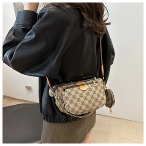 Close-up of retro checkered three-in-one crossbody bag with golden chain straps