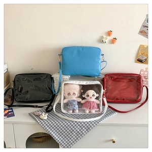 Detailed view of colorful crossbody ita bags with transparent windows for dolls