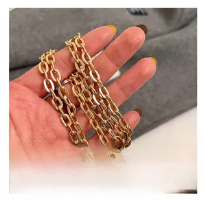 Detail shot of the golden multi-strand chain strap on a leopard print mini bag
