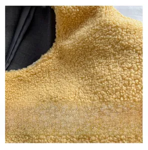 Close-up detail of soft yellow sherpa fleece fabric texture with black lining for tote bag