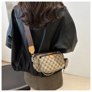 Close-up of three-in-one crossbody bag featuring monogram canvas and wide shoulder strap
