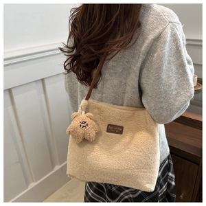 Close-up of winter plush bucket bag featuring soft fuzzy texture and star charm