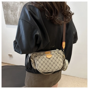Three-in-one beige crossbody bag with monogram pattern and wide brown strap on model