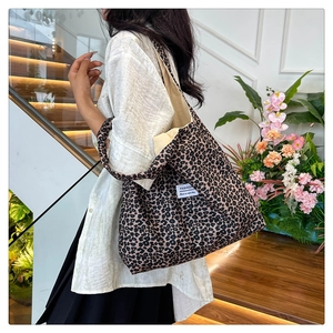 Detail view of large leopard print tote bag with soft fabric and branded textile label