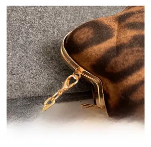 Detail of the golden metal hook and leopard print faux fur texture with crystal accent