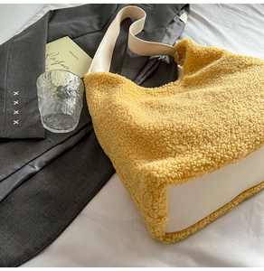 Macro view of large ginger plush tote bag with white leather base and shoulder strap