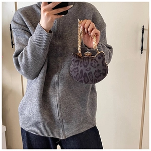 Macro shot of owl-shaped mini leopard print handbag with gold chain and crystal lock