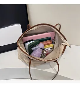 Top view of large cream tote bag showing spacious interior with daily essentials