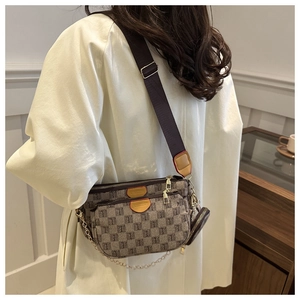 Detailed back view of a 3-in-1 monogram shoulder bag with wide strap and gold chain