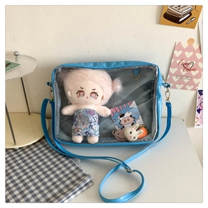 Detail of light blue Japanese style ita bag with transparent window and plush toy interior