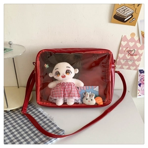 Detail of red leather ita bag with large transparent PVC window for plush doll display