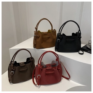 Minimalist drawstring bucket bag in four colors with adjustable shoulder straps and top handles
