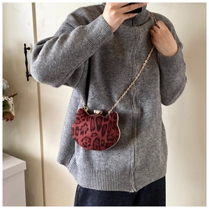 Detailed view of mini cat-shaped leopard print crossbody bag with gold chain strap