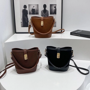 Minimalist bucket shoulder bags in brown, coffee, and black with gold magnetic buckles