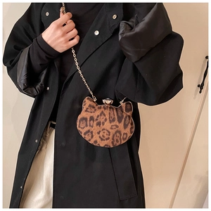 Fashion leopard cat-shaped mini bag with gold chain strap on black wool coat