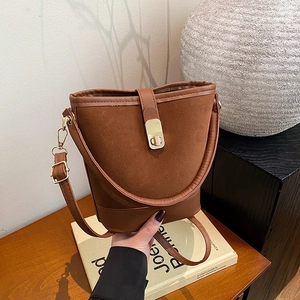 Brown vintage suede bucket bag with gold clasp and adjustable strap for women