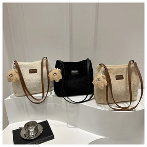 Three plush shoulder bags in white, black, and khaki with cute bear pendants