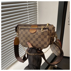 Detailed close-up of brown monogram three-in-one crossbody bag with gold chain and strap