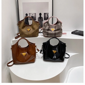 Collection of minimalist tote bags in suede, wool and leather finishes on white display