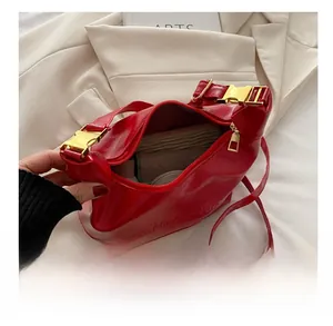 Detailed interior view showing high capacity and golden hardware of red shoulder bag