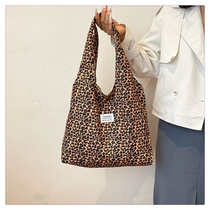 Detailed close-up of a large leopard print tote bag featuring a white Fashion label tag