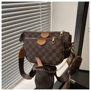 Detail of multi-functional 3-in-1 crossbody bag set in brown checkered pattern and gold chain
