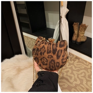 Detailed close-up of leopard print cat-shaped bag with gold chain and crystal clasp