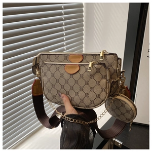 Detail view of vintage multi-pochette crossbody bag with gold chain and wide strap