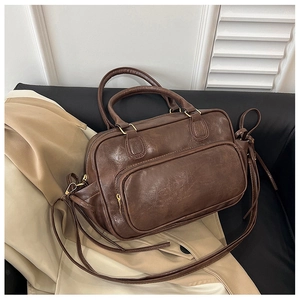 Close-up of brown vintage faux leather texture with golden hardware on travel backpack