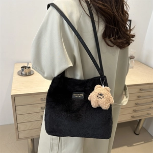 Winter fluffy faux fur hobo bag in black with a cute brown bear charm and leather strap