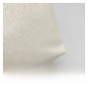 Detailed macro view of white geometric houndstooth embossed texture on large tote bag