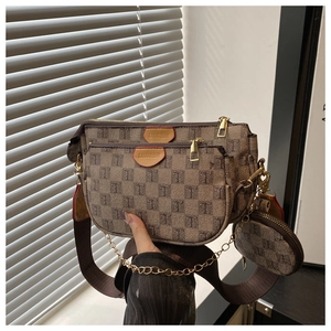 Detail view of retro monogram 3-in-1 crossbody bag set with chain strap and round pouch