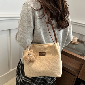 Fashionable beige fuzzy plush tote bag with brown straps and cute yellow star bear charm
