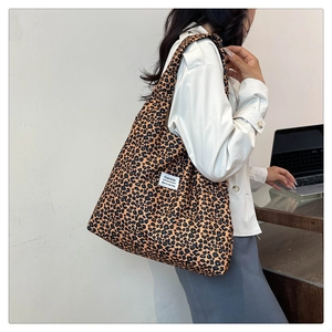 Detailed macro view of large leopard print tote bag with white fashion textile label