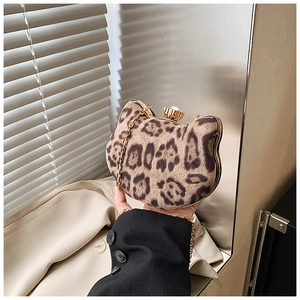 Detail of leopard print cat-shaped bag with gold metal frame and jeweled clasp