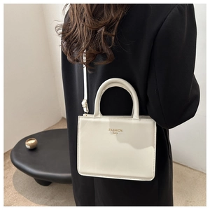 Minimalist cream shoulder bag with golden Fashion Bag lettering on textured faux leather