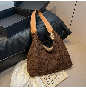 Detail of soft brown teddy plush tote bag with a wide light brown faux leather strap