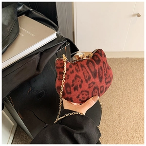 Detail of leopard print cat-shaped handbag with gold chain and crystal clasp