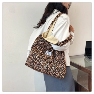 Close-up of leopard print nylon tote bag with fashion label and spacious interior