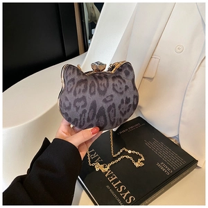 Detail view of cat-shaped leopard evening bag with crystal clasp and gold chain