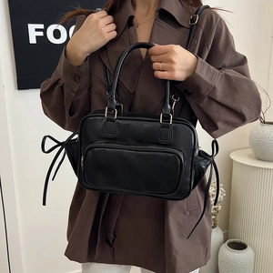 Retro black leather handbag with decorative side bows and gold hardware for women