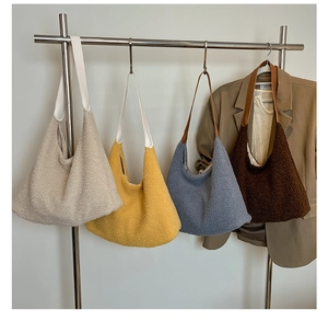 Detail view of large sherpa hobo bags in cream, yellow, blue, and brown fleece textures