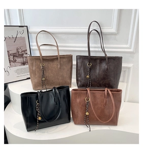 Detail view of retro faux leather tote bags in four colors with braided ring charms