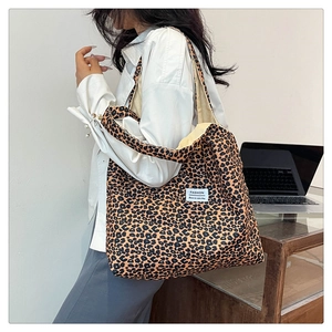 Detailed shoulder view of large leopard print tote bag with stylish fashion woven label