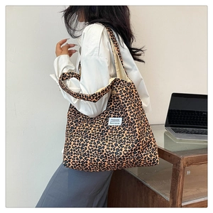Detailed view of leopard print nylon tote bag on shoulder for casual city style