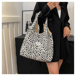Close-up of leopard print tote bag with white fashion label and large capacity design