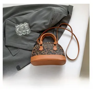 Detailed top view of leopard print shell bag with smartphone for size reference