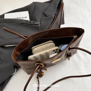 Macro view of the dark brown leather tote bag interior showing its large storage capacity